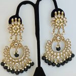 Lushkara Gold-Toned Kundan Jhumka Earrings with Black Bead Accents