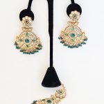 Lushkara Gold-Toned Kundan Jhumka Earrings with Green Bead Accents and Maang Tikka Set