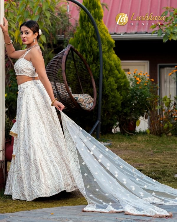 Lushkara White Heavy Sequined Lehenga with Sleveless Blouse and Heavy Latkans and Dupatta - Image 3