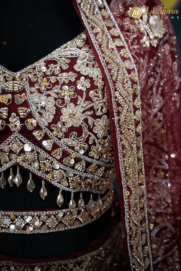 Lushkara Deep Red Bridal Lehenga with Heavy Zardozi and Mirror Work