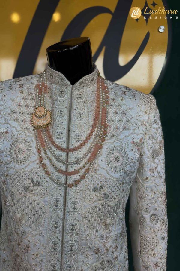 Color: Ivory Fabric: Premium art silk sherwani with matching kurta and pant set Work: Intricate multicolor thread embroidery with traditional floral and geometric motifs Dupatta: Not included (can be added upon request) Occasion: Groom wear, traditional wedding, reception, engagement, or formal festive celebration