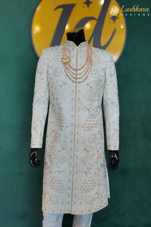 Color: Ivory Fabric: Premium art silk sherwani with matching kurta and pant set Work: Intricate multicolor thread embroidery with traditional floral and geometric motifs Dupatta: Not included (can be added upon request) Occasion: Groom wear, traditional wedding, reception, engagement, or formal festive celebration