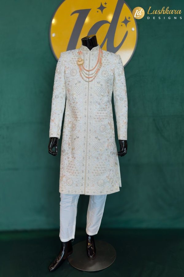 Color: Ivory Fabric: Premium art silk sherwani with matching kurta and pant set Work: Intricate multicolor thread embroidery with traditional floral and geometric motifs Dupatta: Not included (can be added upon request) Occasion: Groom wear, traditional wedding, reception, engagement, or formal festive celebration