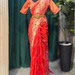 Lushkara Orange-Red Banarasi Saree with Golden Zari Floral Work